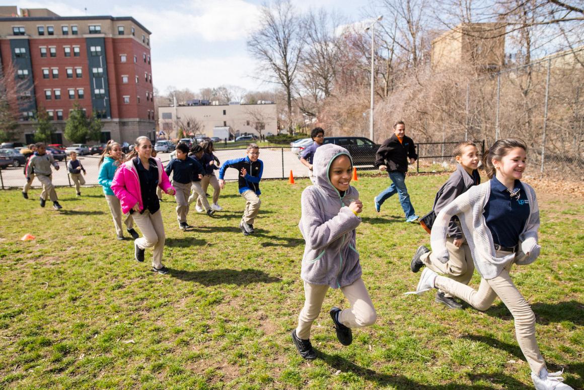 Kids, PE teachers and parents running together as part of the Boston Run Clubs