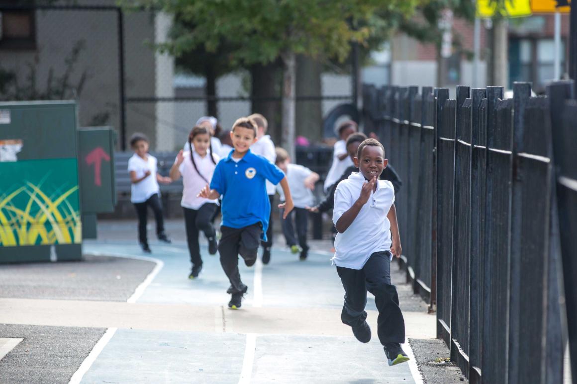 Kids running on a sidewalk as part of the Every School Healthy initiative