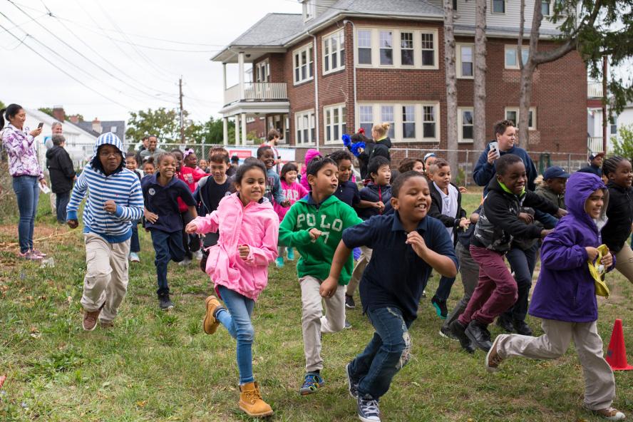 Children running while parents stand and take picures