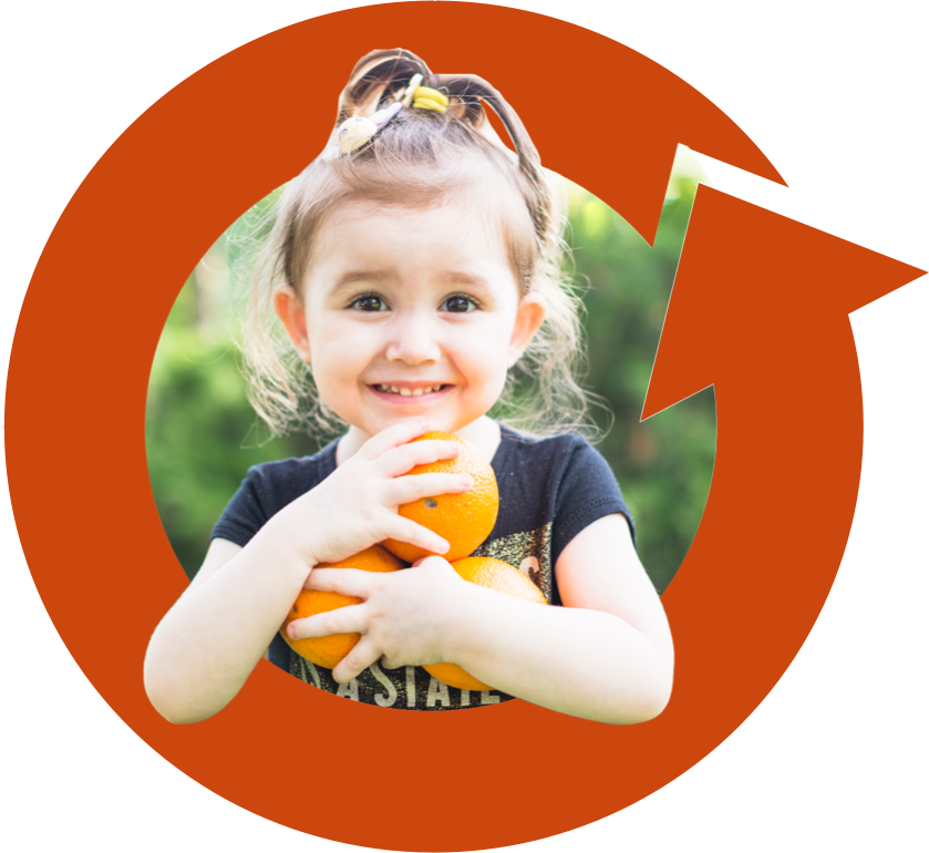 kid holding oranges