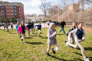 Kids, PE teachers and parents running together as part of the Boston Run Clubs
