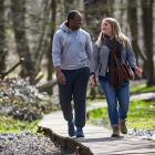 A man and a woman walking on a trail while talking, related to Global Obesity Research